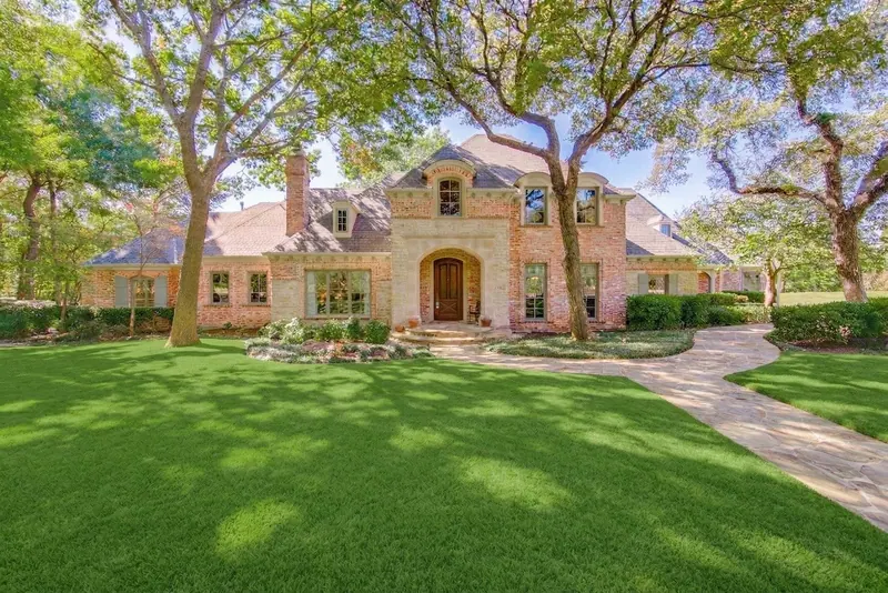 Stone estate home under live oaks in Parker